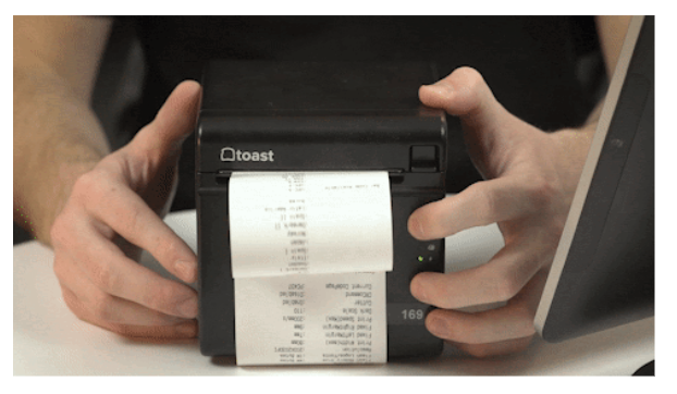 person using two hands to press the feed and power buttons simultaneously